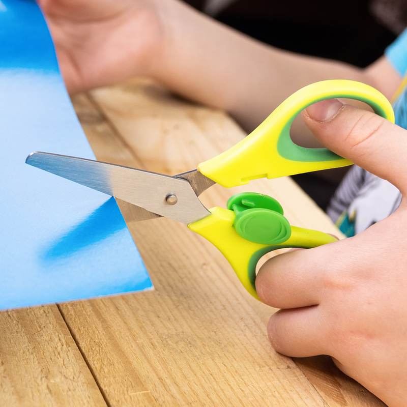 Learning to cut, child holding scissors